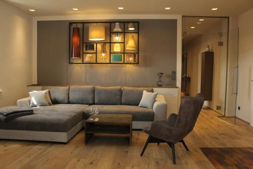 a living room with a couch and a chair at 135qm im Herzen Trofaiachs HS49 in Trofaiach