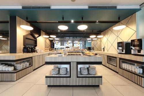 a large kitchen with a counter in a restaurant at Ilirija Resort Hotel Kornati in Biograd na Moru