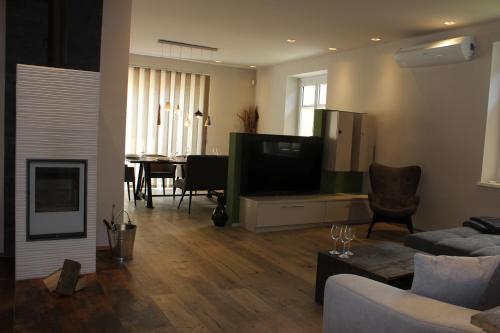 a living room with a couch and a tv and a table at 135qm im Herzen Trofaiachs HS49 in Trofaiach