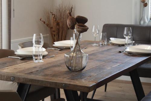 a wooden table with a vase on top of it at 135qm im Herzen Trofaiachs HS49 in Trofaiach
