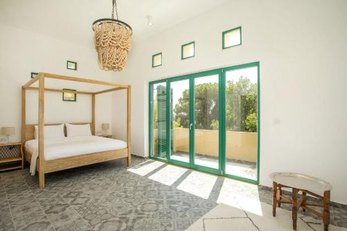 a bedroom with a bed and a large window at Villa Luna Piena in Pefki Rhodes