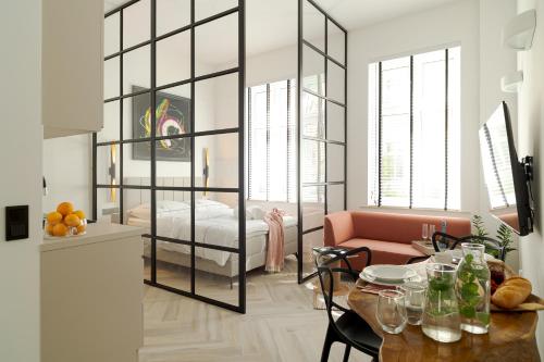 a living room with a bed and a table at Loftowe Zacisze Elbląg in Elblag