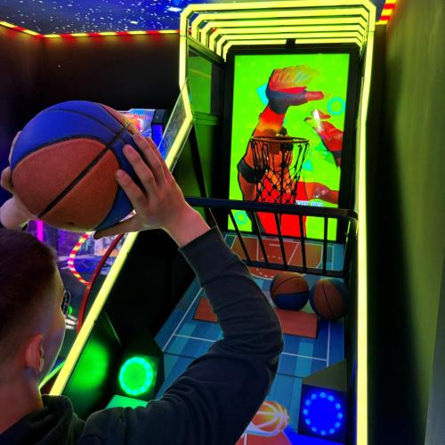 a boy holding a basketball in front of a refrigerator at Grand Laola Spa in Pobierowo
