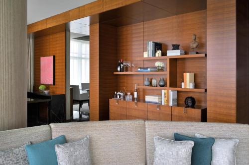 a living room with a couch with pillows at Rosewood Abu Dhabi in Abu Dhabi