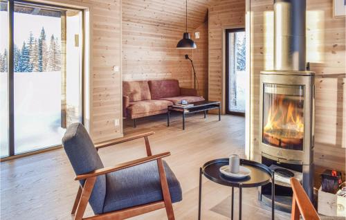 a living room with a fireplace and a couch at 3 Bedroom Amazing Home In Lillehammer in Lillehammer