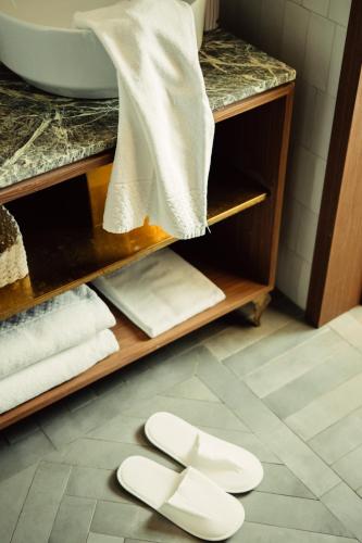 a bathroom with two white toilets on the floor at Horti 14 Borgo Trastevere Hotel in Rome