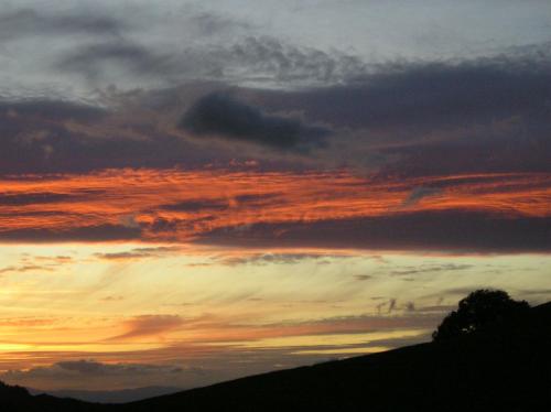 a sunset in the sky over a hill at Dischhansenhof in Glottertal