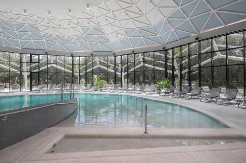 a large swimming pool with chairs in a building at Luxury Glamping Beach Villas Porto Bus in Bale