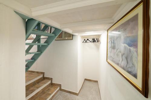 a staircase in a house with a painting on the wall at Radici Etrusche Sutri in Sutri