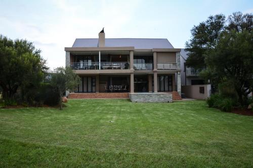 a large house with a lawn in front of it at Kingfisher on Vaal, Parys in Parys