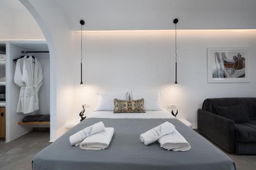a bedroom with a bed with two pillows on it at LyMaRou Collection in Megalokhori