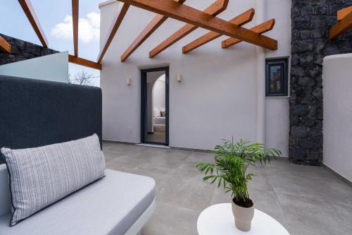 a living room with a white couch and a plant at LyMaRou Collection in Megalokhori