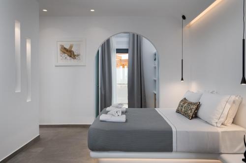 a bedroom with a large bed with a mirror at LyMaRou Collection in Megalokhori