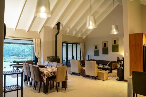 a dining room with a table and chairs at Kingfisher on Vaal, Parys in Parys