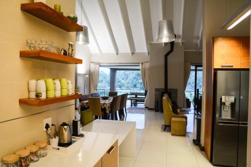 a kitchen with a counter and a dining room at Kingfisher on Vaal, Parys in Parys