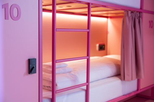 a room with a bunk bed with a ladder at Bunks at Rode in Oslo