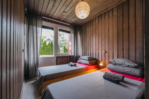 a bedroom with two beds and a window at El Nido in Nida