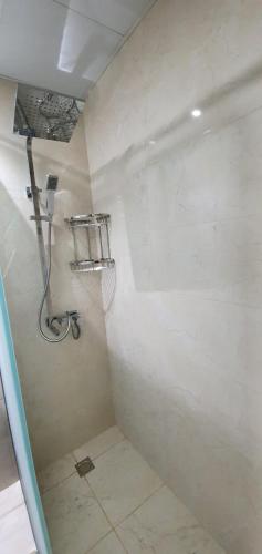 a bathroom with a shower with a shower at Spacious Villa with terrace close to the sea in Ras al Khaimah