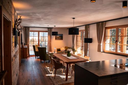 a kitchen and living room with a table and chairs at Chalet WildRuh in Ried im Zillertal