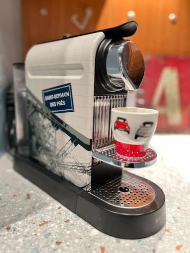 a coffee maker sitting on a counter with a cup at Saint Germain en Laye Hyper Centre Apartment 2 min RER in Saint-Germain-en-Laye
