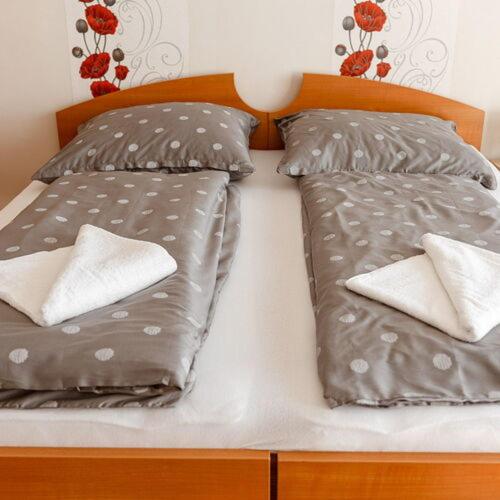a bed with two pillows on top of it at PICNIC Vendégház in Bogács