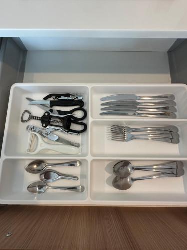 a drawer filled with silver utensils and spoons at Title V in Rawai Beach