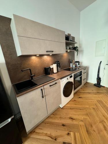 a kitchen with a sink and a stove at Industrial Apartment Schlossberg in Linz