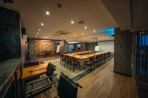 a large dining room with a long table and chairs at Alfa Suites & SPA in Sapanca