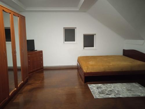 a bedroom with a bed and a dresser in a room at У Софії in Volovets