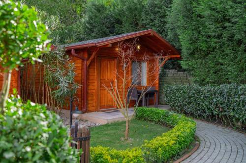 a small wooden cabin with a small tree at Alfa Suites & SPA in Sapanca