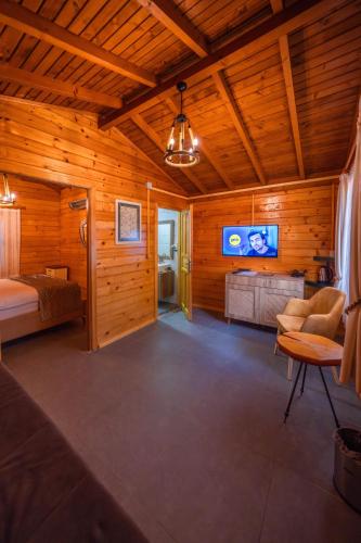 a room with a bed and a tv on the wall at Alfa Suites & SPA in Sapanca