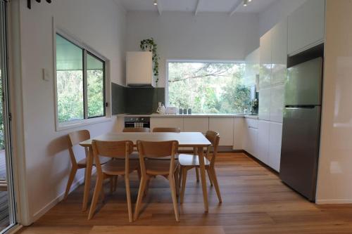 a kitchen with a table and chairs in a room at Satin Bower Cottage in Eagle Heights