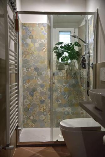 a bathroom with a shower with a toilet and a sink at Suite in Borgo in Greve in Chianti