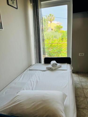a white bed in a room with a window at Dream Apartments in Palaiochóra