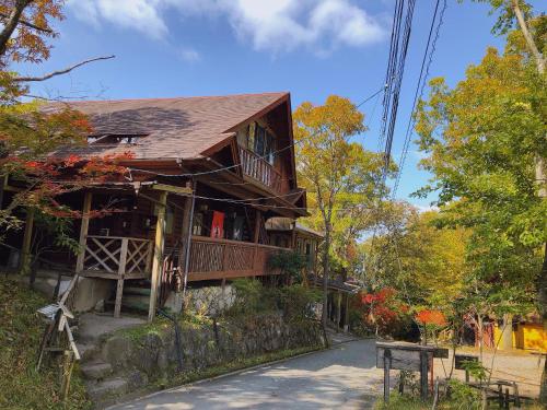 a house on the side of a road at Kurasako Onsen Sakura in Minamioguni