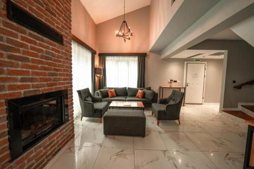 a living room with a couch and a fireplace at Alfa Suites & SPA in Sapanca