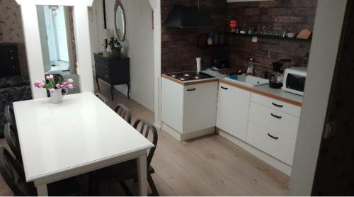 a kitchen with a table and a white counter top at Villa VINCENT in Naantali