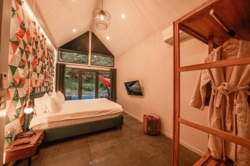 a small bedroom with a bed and a window at Alfa Suites & SPA in Sapanca