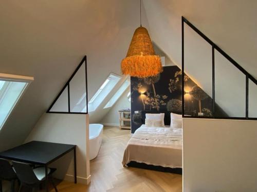 a bedroom with a bed and a chandelier at Ricks Room Barneveld in Barneveld