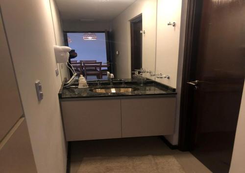 a bathroom with a sink and a mirror at Veneto Village - Vista al Lago - 10 minutos a Carlos Paz in Villa Parque Siquiman