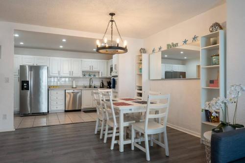 a kitchen with a table and chairs and a refrigerator at Ocean Reserve Condominium in Miami Beach