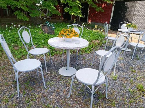 a group of tables and chairs with flowers on them at Villa VINCENT in Naantali