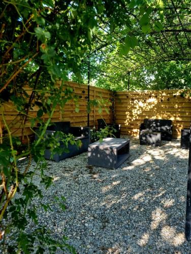 a backyard with a bench and a wooden fence at Villa Provençale in Beaumes-de-Venise