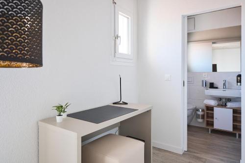 Un baño blanco con lavabo e inodoro. en Aabach Hotel, en Wetzikon