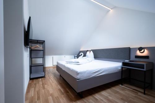 a bedroom with a bed and a television in it at Gasthaus Rössle in Nenzing