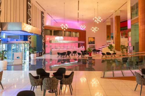 a lobby with chairs and tables in a building at Crystal Centro Resort - Ultimate All Inclusive in Lara
