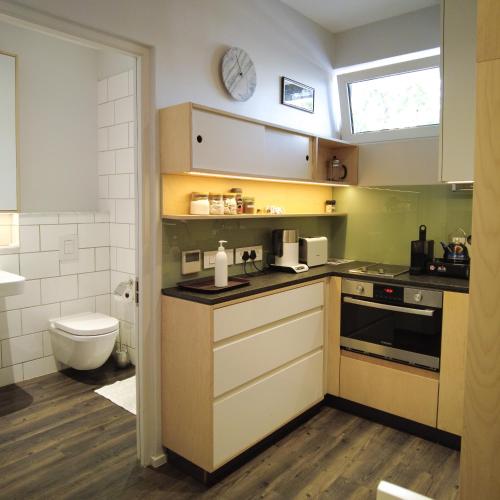 a kitchen with a sink and a stove top oven at Laanhof Studios in Stellenbosch
