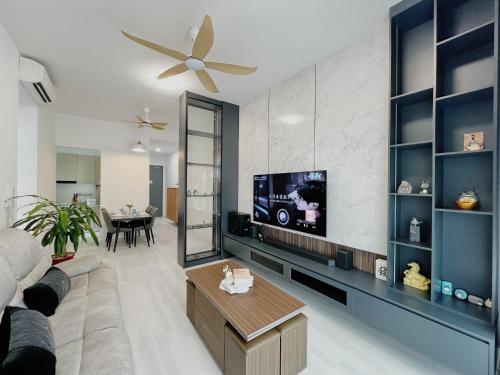 a living room with a flat screen tv on a wall at Paradigm Residence by Antlerzone in Johor Bahru