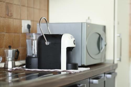 a kitchen counter with a mixer and a microwave at Hostel Osho in Tirana