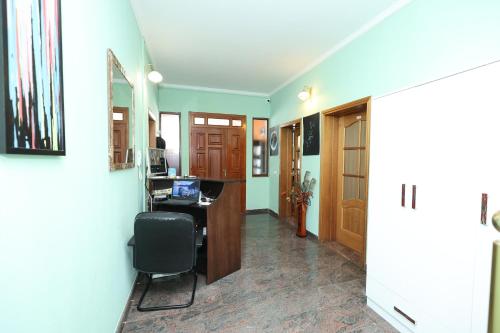 an office with a desk and a chair in a hallway at Hostel Osho in Tirana